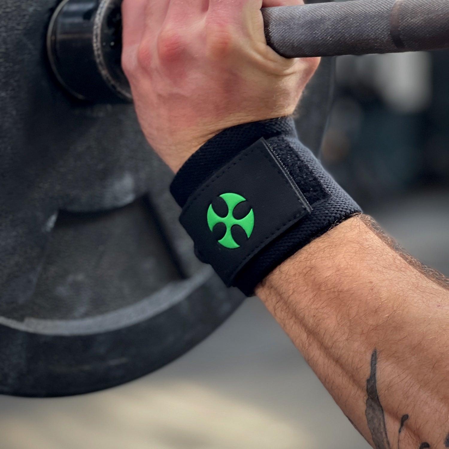 Reyllen No Thumb Loop Wrist Support Lifting Wraps Black worn on wrist lifting barbell