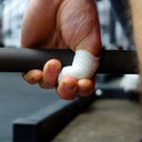 Reyllen FLEXTape thumb tape in use on a barbell lift
